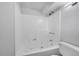 Bathroom with a white shower-tub combo, toilet, and showerhead at 11157 W Marlowe Ave, Jefferson, CO 80127