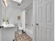 Bathroom featuring patterned floors, a shower-tub combo, a white vanity and white walls at 11157 W Marlowe Ave, Jefferson, CO 80127