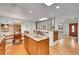 Open kitchen with granite countertops, stainless appliances, wooden cabinets, and skylights at 11157 W Marlowe Ave, Jefferson, CO 80127
