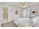 Main bedroom with a metal bed frame, carpeted floors, neutral walls, a ceiling fan and an ensuite bathroom at 11157 W Marlowe Ave, Jefferson, CO 80127