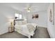 Main bedroom with a metal bed frame, carpeted floors, two windows, neutral walls and a ceiling fan at 11157 W Marlowe Ave, Jefferson, CO 80127