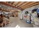Unfinished basement with a concrete floor, exposed wooden beams, and ample storage space at 13151 Ivanhoe St, Thornton, CO 80602