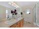 Bright bathroom with double sinks, large mirror, and tiled floors at 13151 Ivanhoe St, Thornton, CO 80602