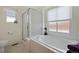 Bright bathroom featuring a soaking tub, a shower with glass door, and multiple windows at 13151 Ivanhoe St, Thornton, CO 80602