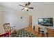 Bedroom with hardwood flooring, ceiling fan and a desk area, plus a closet for storage at 13151 Ivanhoe St, Thornton, CO 80602