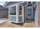 Close-up of the front entryway, highlighting the bay window, blue siding, and brick detail at 13151 Ivanhoe St, Thornton, CO 80602