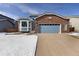 Inviting two-story home featuring a brick facade, blue siding, and an attached two-car garage at 13151 Ivanhoe St, Thornton, CO 80602