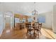 Open-concept eat-in kitchen featuring an island, wood cabinets, and a dining table at 13151 Ivanhoe St, Thornton, CO 80602
