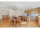 Eat-in kitchen with hardwood floors and a dining area featuring a modern light fixture at 13151 Ivanhoe St, Thornton, CO 80602