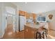 Bright kitchen boasts an island with seating, wood cabinets, and updated appliances at 13151 Ivanhoe St, Thornton, CO 80602