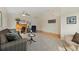 Inviting living room with hardwood and carpet flooring, warm colors, and an open layout at 13151 Ivanhoe St, Thornton, CO 80602