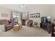Inviting living room with comfortable seating, a large TV, and bright windows overlooking the backyard at 13151 Ivanhoe St, Thornton, CO 80602