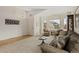 Bright and airy living room featuring neutral colors, large windows, and comfortable seating arrangements at 13151 Ivanhoe St, Thornton, CO 80602