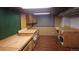 Large basement workshop with wooden floors, ample counter space, and plenty of storage cabinets at 4693 Chatham St, Boulder, CO 80301