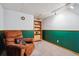 Cozy finished basement area with a comfortable armchair and built-in shelving, perfect for relaxing at 4693 Chatham St, Boulder, CO 80301