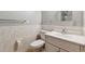 Clean bathroom featuring a white vanity, toilet, and tiled walls, creating a bright and functional space at 4693 Chatham St, Boulder, CO 80301