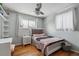 Charming bedroom featuring hardwood floors, a decorative ceiling fan, and soft, natural lighting at 4693 Chatham St, Boulder, CO 80301