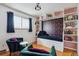 Stylish bedroom with built-in bookshelves and a cozy daybed, creating a perfect reading nook at 4693 Chatham St, Boulder, CO 80301