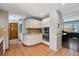 Spacious kitchen featuring white cabinets, stainless steel appliances, and a view into the dining room at 4693 Chatham St, Boulder, CO 80301