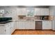 Well-lit kitchen featuring white cabinets, stainless steel appliances, and tile flooring at 4693 Chatham St, Boulder, CO 80301