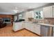 Bright kitchen featuring white cabinets, stainless steel appliances, tiled floor, and a large window offering natural light at 4693 Chatham St, Boulder, CO 80301