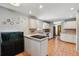 Bright kitchen featuring white cabinets, stainless steel appliances, and an aquarium at 4693 Chatham St, Boulder, CO 80301