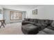Spacious living room featuring a large sectional sofa, plush carpeting, and a bright window at 4693 Chatham St, Boulder, CO 80301