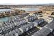 Aerial view of a modern townhome community near a lake with mountain views at 3481 W 63Rd Ave, Denver, CO 80221