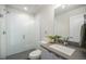 Bathroom featuring a glass-enclosed shower with white tiled walls and a modern vanity with gray countertops at 3481 W 63Rd Ave, Denver, CO 80221