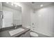 Bathroom with bathtub and shower, white tile, large mirror and lighting at 3481 W 63Rd Ave, Denver, CO 80221