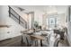 Bright dining room with a modern chandelier, stylish table, and staircase at 3481 W 63Rd Ave, Denver, CO 80221