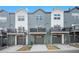 Modern townhome with garage, balcony, and gray and white color scheme at 3481 W 63Rd Ave, Denver, CO 80221
