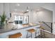 Modern kitchen island with seating, stainless steel appliances, and adjacent outdoor access at 3481 W 63Rd Ave, Denver, CO 80221