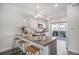 Well-lit kitchen featuring an island with bar stools, modern appliances, and seamless access to deck at 3481 W 63Rd Ave, Denver, CO 80221