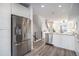 Spacious kitchen with stainless steel refrigerator, modern fixtures, and open layout at 3481 W 63Rd Ave, Denver, CO 80221