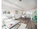 Open-concept living and dining area with modern decor and hardwood floors at 3481 W 63Rd Ave, Denver, CO 80221