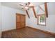 Bright bedroom with wooden ceiling beams, hardwood floors, closet and a window offering scenic outdoor views at 297 Robertson Ln, Breckenridge, CO 80424