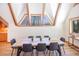 Bright dining room features vaulted ceilings, wooden beams, and a picturesque window view of the surrounding landscape at 297 Robertson Ln, Breckenridge, CO 80424