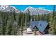 Mountain home with roof, A-frame design, wood paneling and surrounded by lush forest near mountain peaks at 297 Robertson Ln, Breckenridge, CO 80424