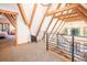 Open hallway showcasing exposed beams, black railing and view into bedroom with natural light at 297 Robertson Ln, Breckenridge, CO 80424