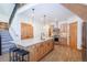 Open kitchen featuring wood cabinets, stainless appliances, marble countertops and adjacent staircase at 297 Robertson Ln, Breckenridge, CO 80424