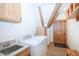 Convenient laundry room with modern appliances, granite countertops, ample storage, and natural wood accents at 297 Robertson Ln, Breckenridge, CO 80424