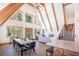 Spacious open living area with exposed beams, a dining table and direct access to the island kitchen at 297 Robertson Ln, Breckenridge, CO 80424