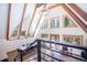 Bright living room with vaulted ceilings, wooden beams, and multiple windows offering scenic outdoor views at 297 Robertson Ln, Breckenridge, CO 80424