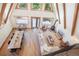 Aerial view of open-concept living room, dining area, modern kitchen, fireplace and vaulted ceilings with exposed beams at 297 Robertson Ln, Breckenridge, CO 80424