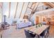 Open-concept living room boasts vaulted ceilings, a fireplace, a modern kitchen, and dining area with mountain views at 297 Robertson Ln, Breckenridge, CO 80424