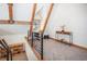 Inviting loft area with a workstation, bookshelf, and railing, showcasing wood beams and natural light at 297 Robertson Ln, Breckenridge, CO 80424