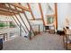 Cozy loft featuring a desk, chair, and natural light from a window, complemented by exposed wooden beams at 297 Robertson Ln, Breckenridge, CO 80424