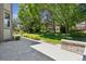 Backyard patio with stone pavers, green landscaping and a large grassy area at 6393 S Jamaica Ct, Englewood, CO 80111