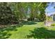 Large grassy backyard with mature trees, and well-manicured lawn at 6393 S Jamaica Ct, Englewood, CO 80111